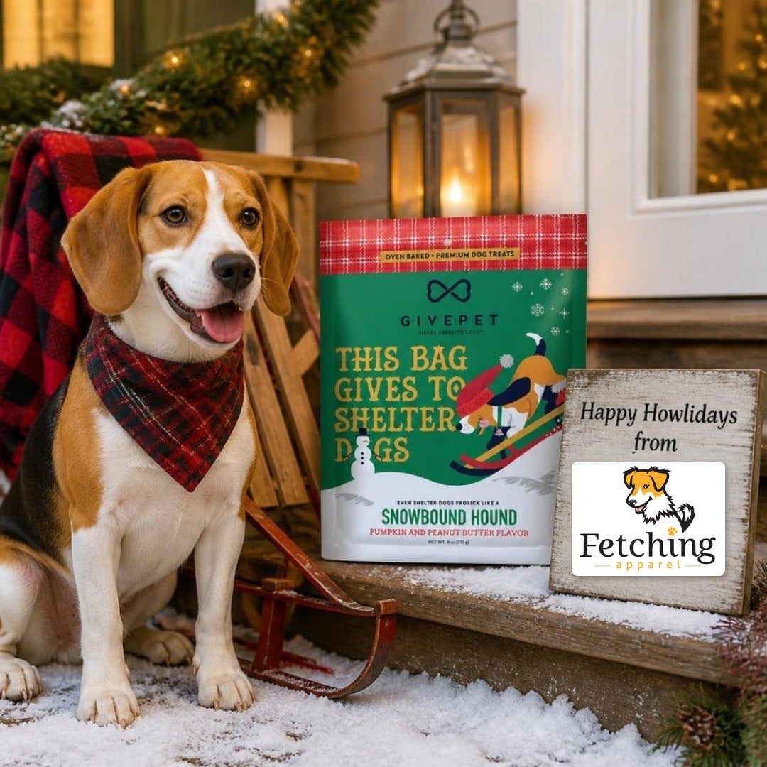 Beagle on a snowy porch with a bag of Snowbound Hound holiday dog biscuits and a Happy Howlidays sign with the Fetching Apparel logo