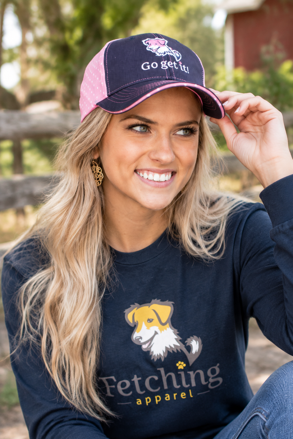 Navy baseball cap with pink polka-dot panel and logo patch, adjustable strap closure