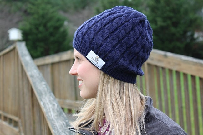 The Fetching Apparel cozy cable knit hat in navy. Perfect for winter walks with your dog.